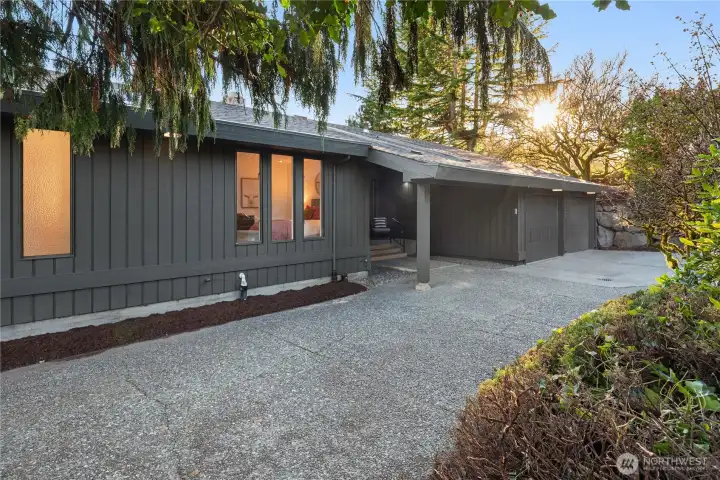 The front is wonderfully private with a large exposed aggregate patio that leads down to the lower level on the left side of the house.