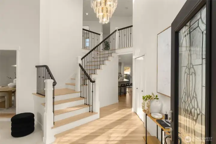 A grand wrought-iron spindle staircase makes a striking statement as it leads upstairs.