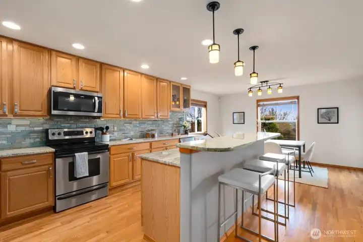 Updated kitchen features breakfast bar and ample storage options.