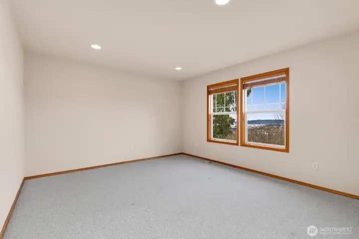 Bedroom 3 of 4 on upper level. This spacious bedroom offers a walk-in closet.