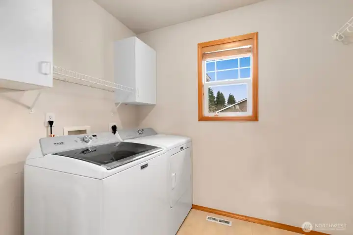 Upper level laundry room with storage.