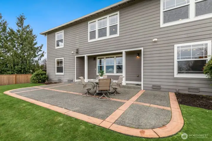 Backyard features great patio with covered space for grilling and storage.