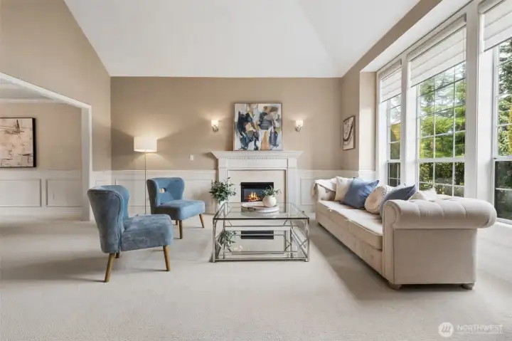 As you come in the house, just to the right is the living room with gas fireplace, cathedral ceiling and a bank of windows for natural light.
