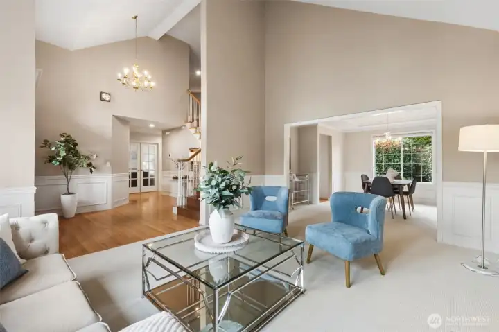 Formal living room into the entry and showing the 5th bedroom, or main floor office along with the stairway to the bedrooms. Imagine how big of a Christmas Tree you could have here!!!