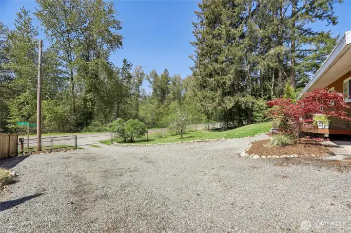 Spacious gravel driveway with ample parking.