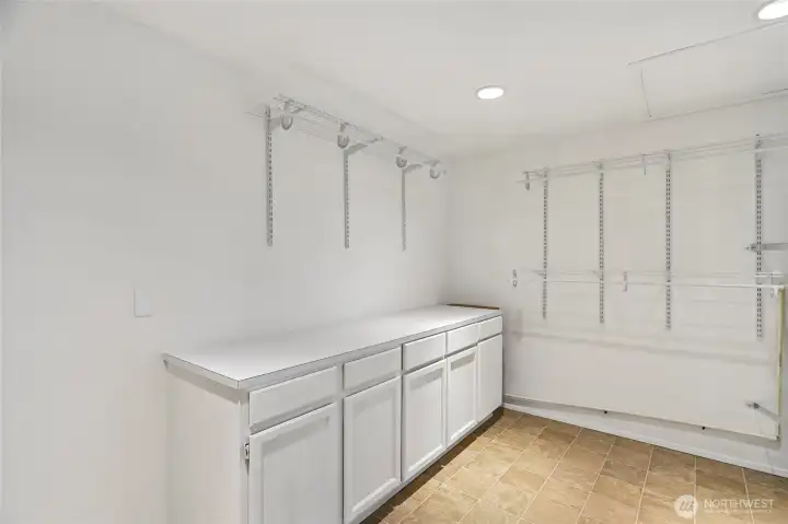 Dedicated laundry room with storage.