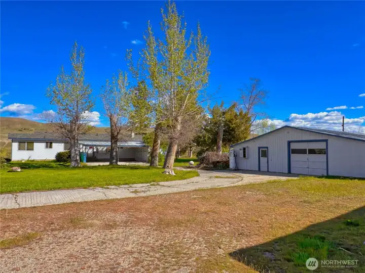 Updated 4-bedroom, 2.75-bath home offering 3,208 sq ft of living space, plus a carport, detached garage/shop with lean-to, equipment shed, and versatile outbuildings to suit a variety of lifestyle needs.