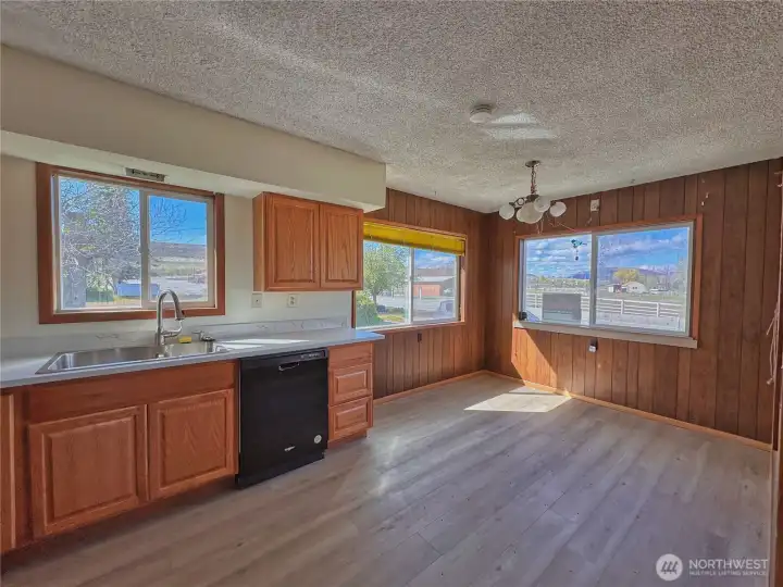 Bright, open kitchen with a breakfast dining area and wall-to-wall windows that maximize natural light