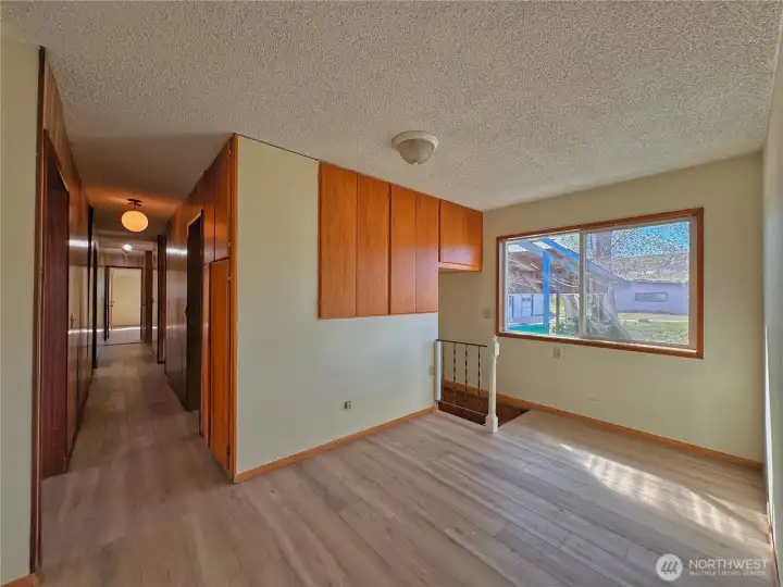 Versatile room from carport entry has built in storage and direct stair access, offering easy flow and mudroom options