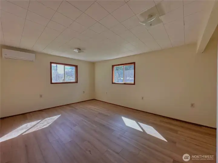 Spacious primary bedroom with ample room for a sitting area and abundant natural light
