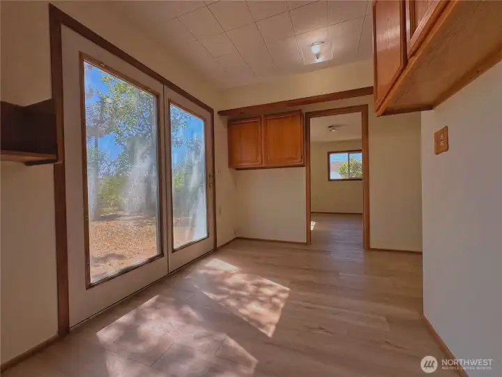 French doors lead to side room off primary bedroom