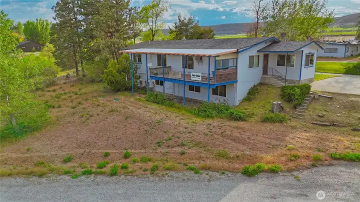 Back of home view with yard space to lower level entrance