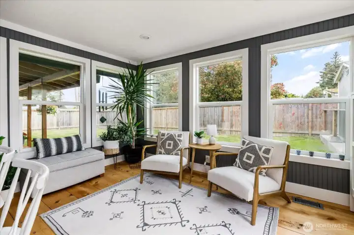 The sun room off the kitchen creates another area to chill with a good book and a cup of tea.