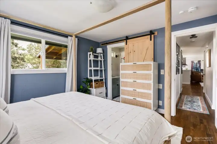 View looking from the bed towards the en-suite bathroom and down the main hallway.