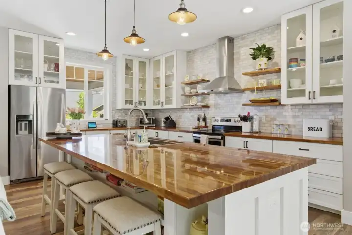 Gleaming black walnut counters create a dramatic kitchen area