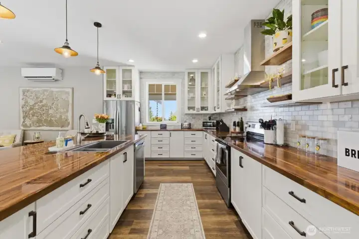 Custom cabinets and window to the view over kitchen sink.