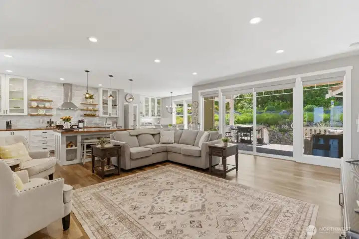 The large south-facing windows and sliding doors invite light into the living area.