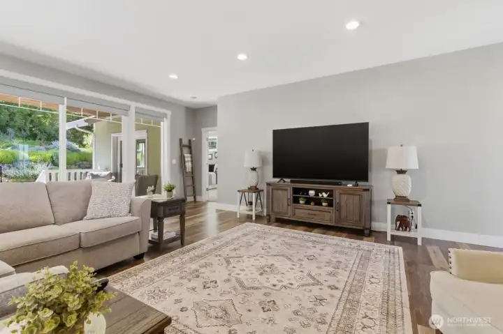 Living room with large sliding doors to the covered rear deck blend indoor and outdoor living.