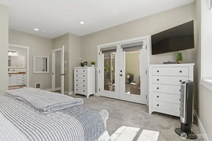 French doors lead from the primary bedroom to the covered rear deck.