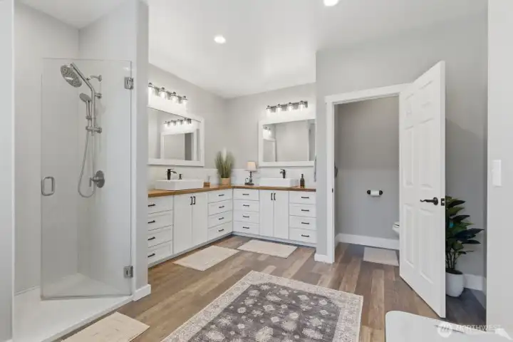 A low entry, walk-in shower is a feature of the large primary bathroom.