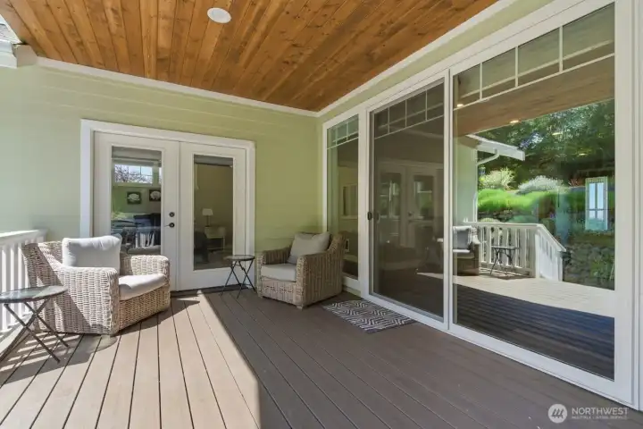 Covered rear deck has access to living areas and primary bedroom.