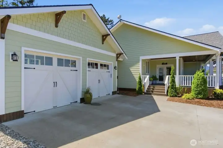 A broad concrete driveway provides additional parking and convenient access to the covered front porch and inearby den.