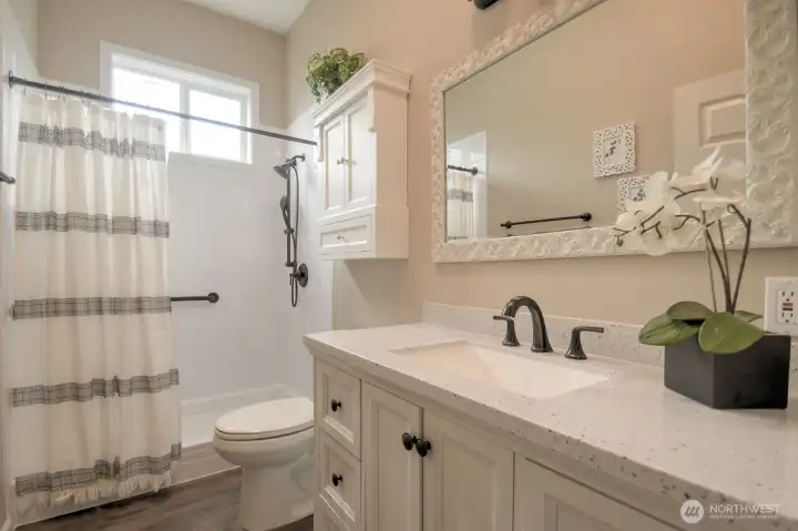 Bathroom offers natural light of a skylight and a new, low barrier shower. Vanity with lots of drawers. Bathroom offers natural light of a skylight and a new, low barrier shower. Vanity with lots of drawers.