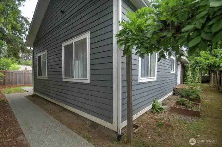 A few simple garden beds for kitchen herbs on the side then a sidewalk leads out back. A few simple garden beds for kitchen herbs on the side then a sidewalk leads out back.
