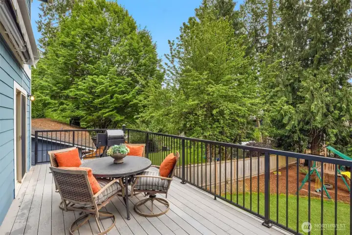 The large low-maintenance composite deck features a motorized SunSetter awning, gas stub for grilling, and beautiful backyard views. The large low-maintenance composite deck features a motorized SunSetter awning, gas stub for grilling, and beautiful backyard views.