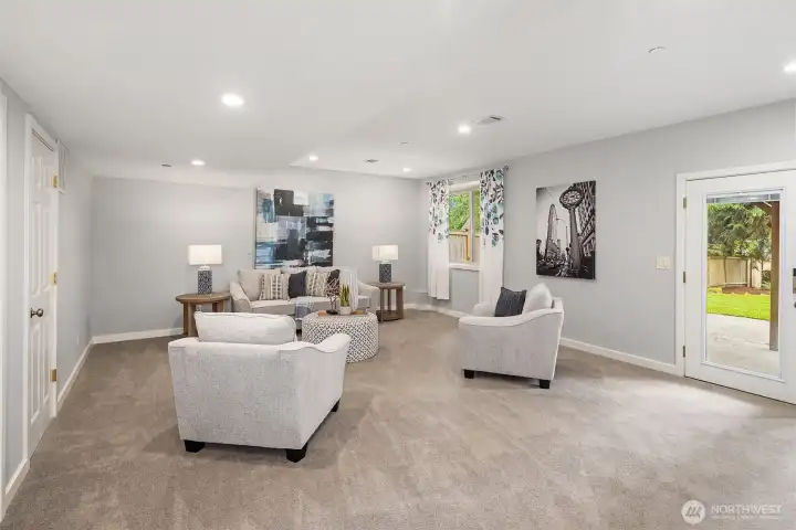 The lower level bonus room has tall ceilings, natural light, and walkout access to the patio and dreamy backyard. The lower level bonus room has tall ceilings, natural light, and walkout access to the patio and dreamy backyard.