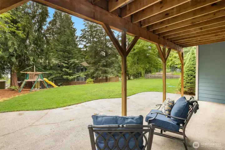 The large patio is accessed from the lower level bonus room and overlooks the park-like backyard. The large patio is accessed from the lower level bonus room and overlooks the park-like backyard.