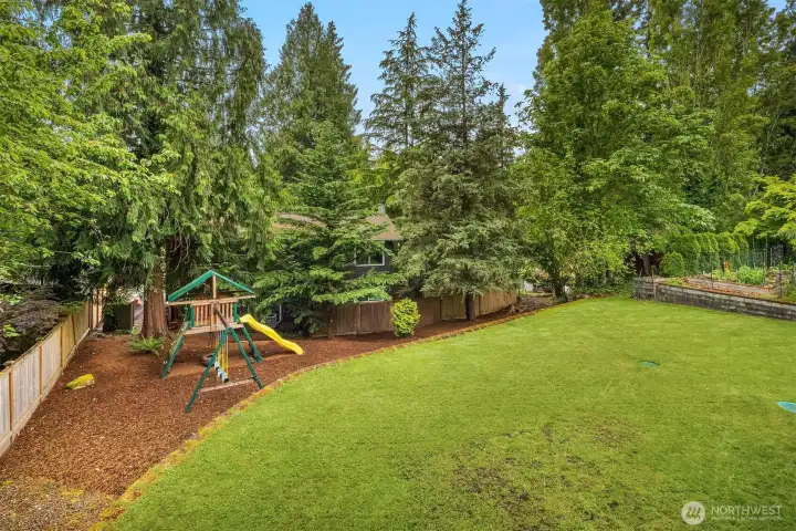 Large backyard has mature privacy landscaping and lots of room to play. The play structure is included in the sale. Large backyard has mature privacy landscaping and lots of room to play. The play structure is included in the sale.
