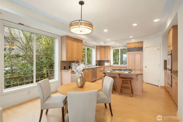 The open kitchen, casual dining nook & family room form a natural gathering hub.