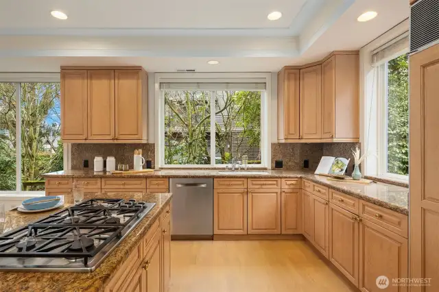 Dacor 5-burner gas cooktop faces out from the island in this social layout.