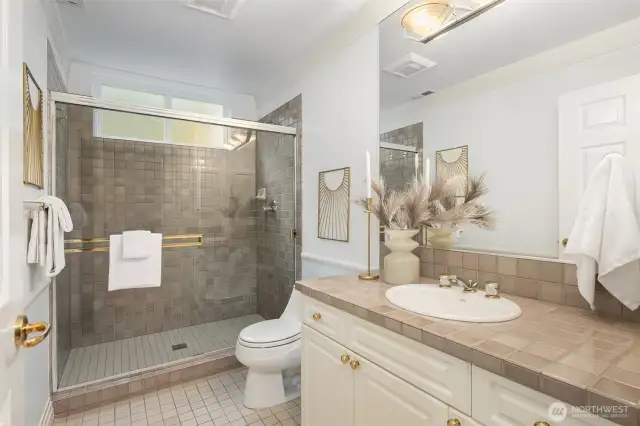 Guest bath off the hallway with an extra-large tiled shower.