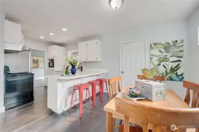 Relax on a bright red barstool and cheer the chef on.