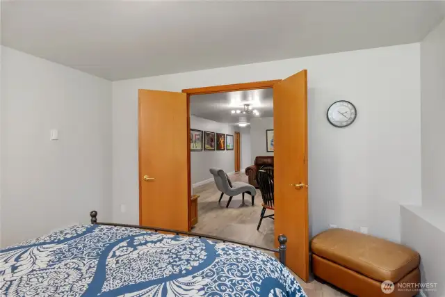 French doors of the bonus room lead to the rec room.