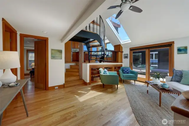 Enter the living room with vaulted ceilings and skylights. One bed/office/or both is on this level as well as the full bathroom and laundry.