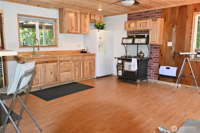 Newly painted kitchen that highlights the wood cabinetry.