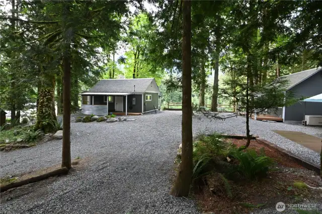 Introducing "Above the Sky" ~ so much to offer with two cozy cabins, a 40' container, separate washhouse w/full laundry, and two EV chargers. Each cabin is equipped with its own Generac generator, ensuring reliable backup power.