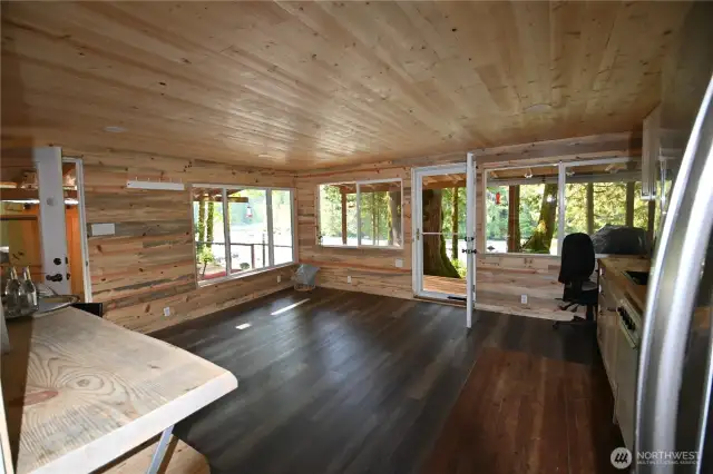 Bunkhouse features new doors, windows, updated flooring, half bath - blending modern upgrades w/rustic character. A touch of original fir floor has been preserved to stencil or paint your own design & infuse the space with personality.