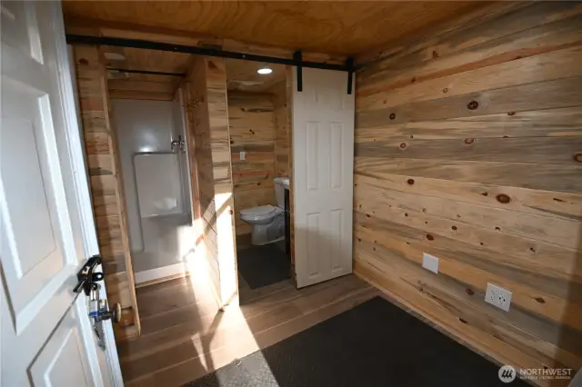 The washhouse a separate building featuring shower w/infrared heater, on-demand hot water, full laundry setup and space to add a sauna.