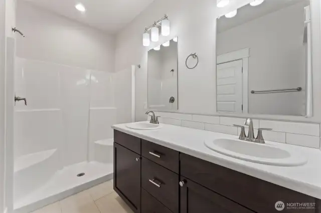 Primary bathroom with walk-in closet and double sinks