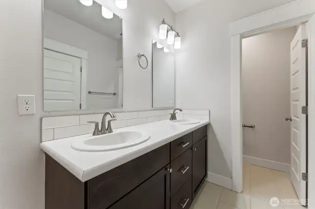 Primary bathroom showing separate toilet room