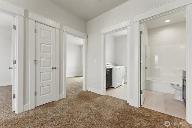Upstairs showing full bath and laundry room