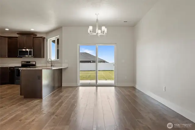 Dining area with glass slider out to covered patio