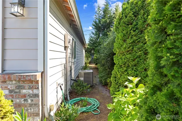 The side yard houses the heat pump which provides year-round comfort. System includes a HEPA filter and a paid maintenance plan good for 3+ more years!