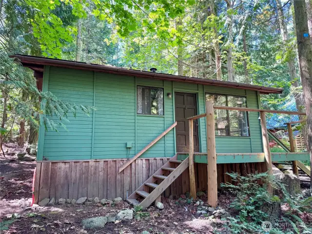 A quaint cabin in the woods just waiting to make someone's ideal vacation spot!