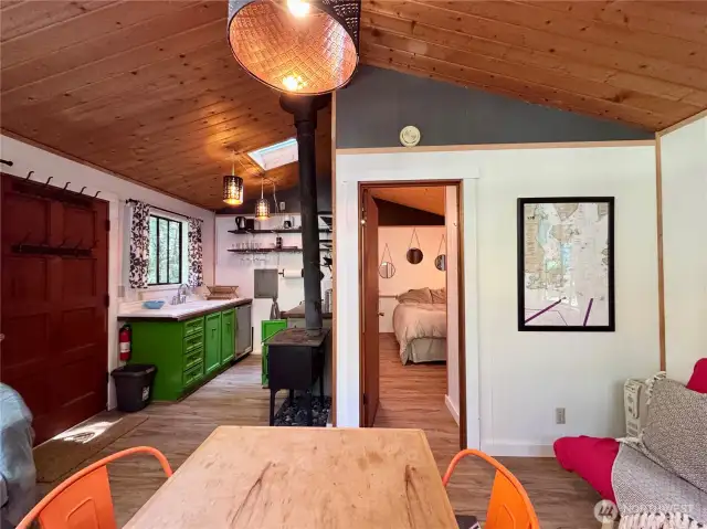 Open floor plan with wood ceilings and vinyl plank flooring.