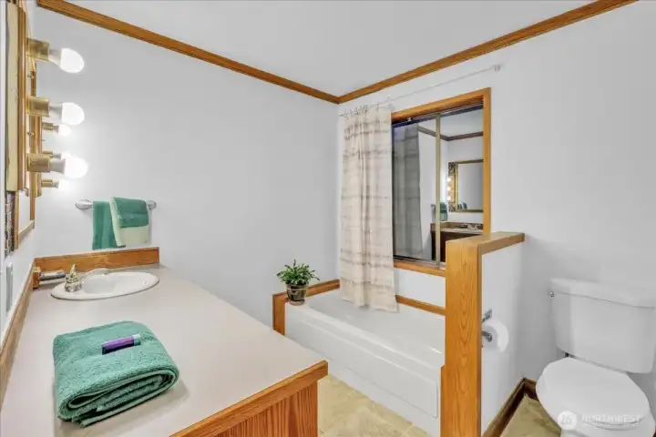 Guest bath on main level features a bath tub.